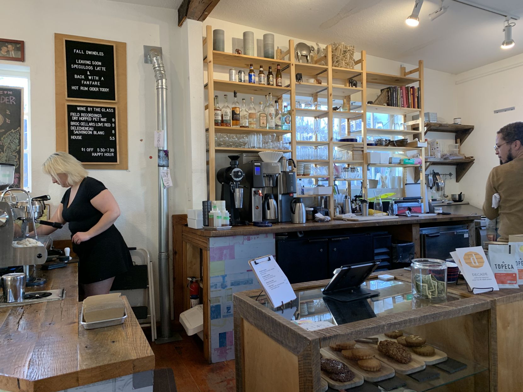 A Decade barista prepares a drink behind a counter